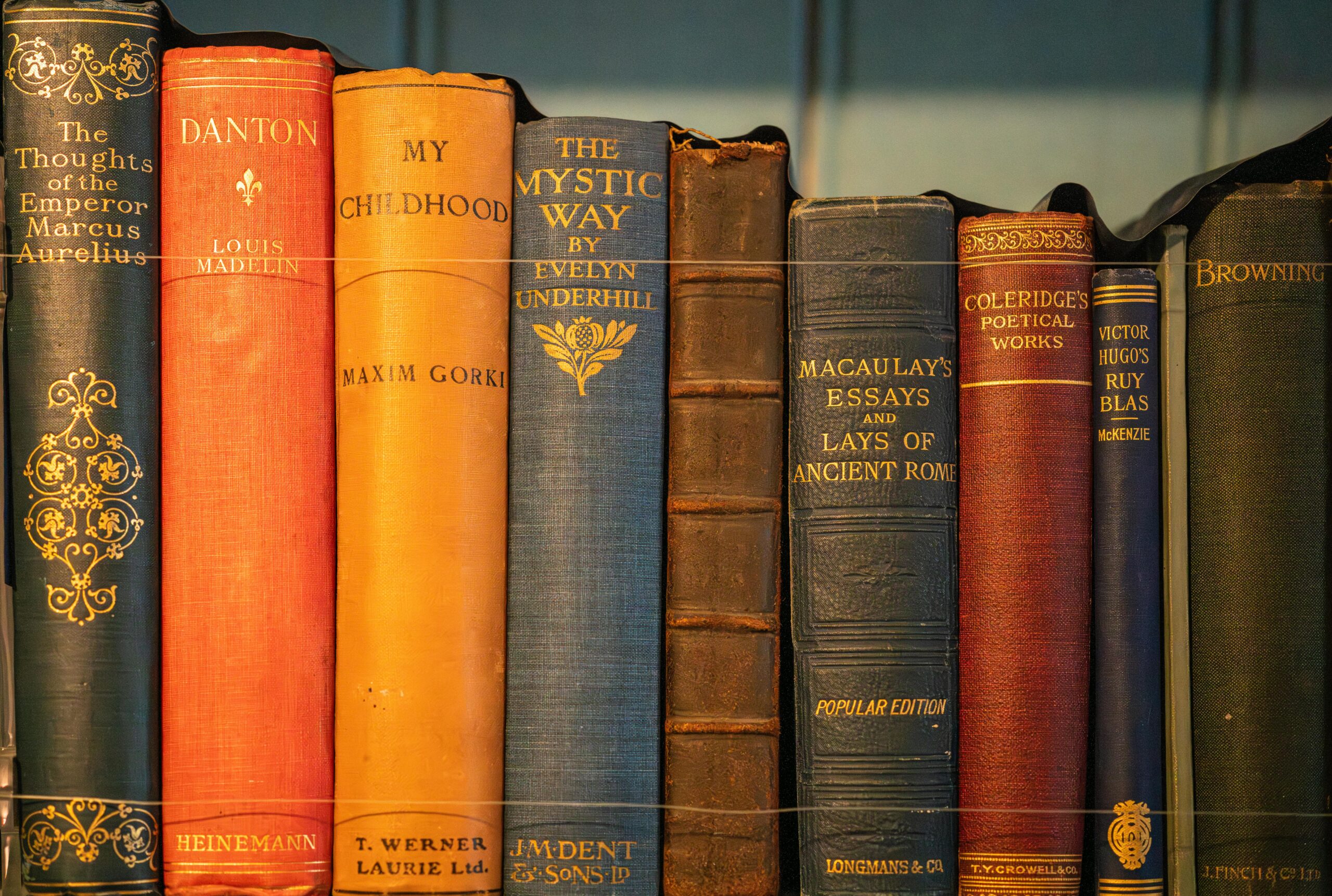 A collection of vintage books displayed on a shelf, showcasing classic literature.
